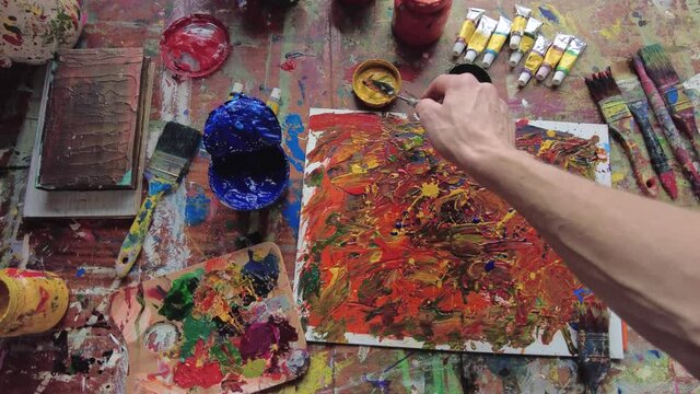 Painter in workspace creating modern art