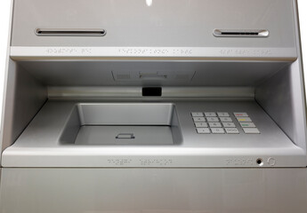 a modern ATM with recycling function and braille code as well as a headphone jack