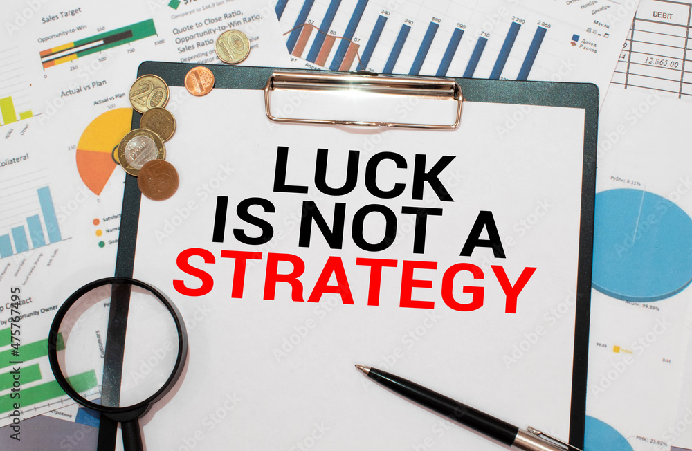 Poster luck is not a strategy text on a notebook on office desk