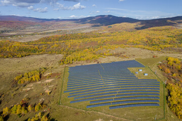 There are many solar panels near the forest. Ecology concept with solar panels. View from above