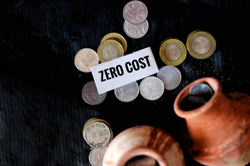 Closeup of coins and clay jugs with a small piece of paper with a message.