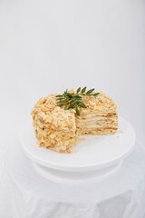 Napoleon cake in a cut on a white tray isolated on a white background. Cake of puff pastry with sour cream. Copy space. 