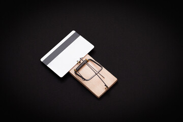 Credit Risk and Loan Trap - White Blank Credit Card Template in Wooden Mouse Trap on Black Background