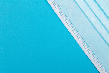 Blue Medical Mask on Blue Background - Top View, Flat Lay
