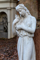 Obraz premium Historic Statue on the mystery old Prague Cemetery, Czech Republic