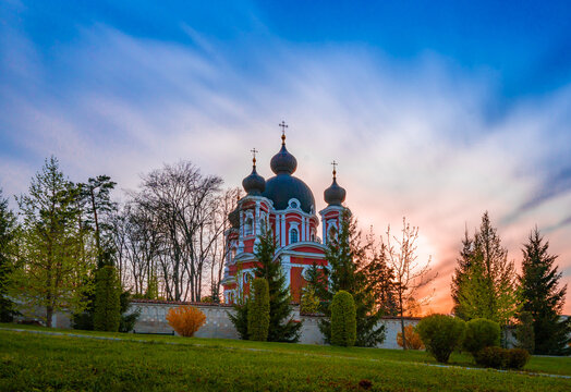 Curchi Monastery surrounded by a garden during the sunrise in Curchi, Moldova