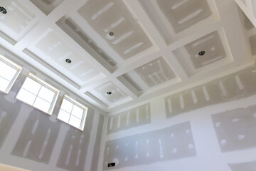 Plastering drywall new home industry on finishing putty in the room walls plasterboards with room...