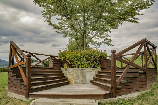 Wooden Stairs Under The Green Tree With A View To The Beautiful Land With Dense Vegetation