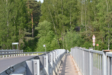 Holders of metal fenders of the automobile bridge. Guard rail, security metal or iron fence on the...