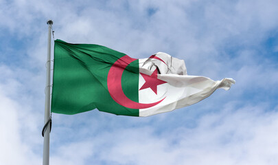 Algerian flag waving on a pole in a blue sky