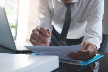 Businessman reading carefully terms, conditions of business contract, close-up