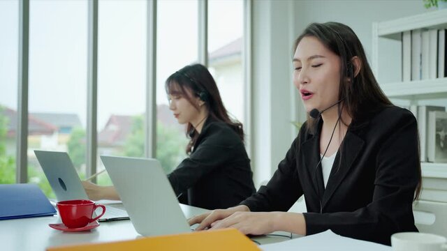 Asian transgender woman call center, Customer support agent or call center with headset works on desktop computer . The concept of coexistence in society Transgender,Lgbt,LGBTQ

