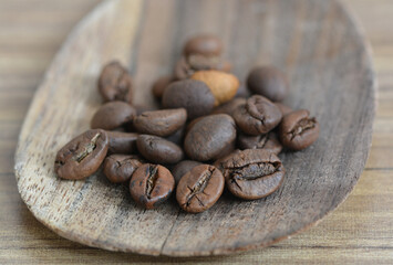 Close-up view of roasted robusta coffee beans with blurred coffee background