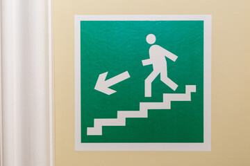 An icon on the wall indicating the exit direction.