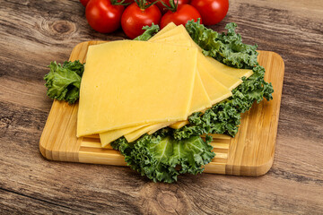 Sliced Gauda cheese over board