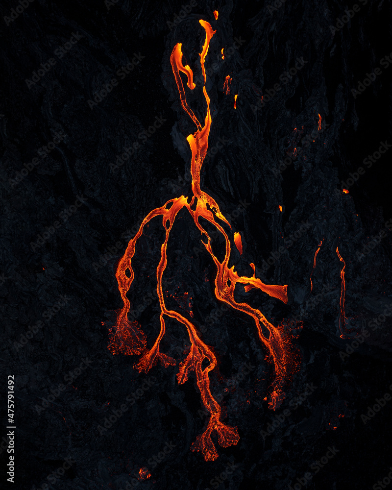 Poster A vertical shot of lava rivers from the active volcano