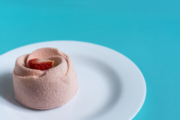 Airy strawberry cake with pink sponge cake on a white background copy space