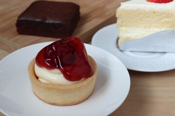 close-up strawberry cheese tart on white plate