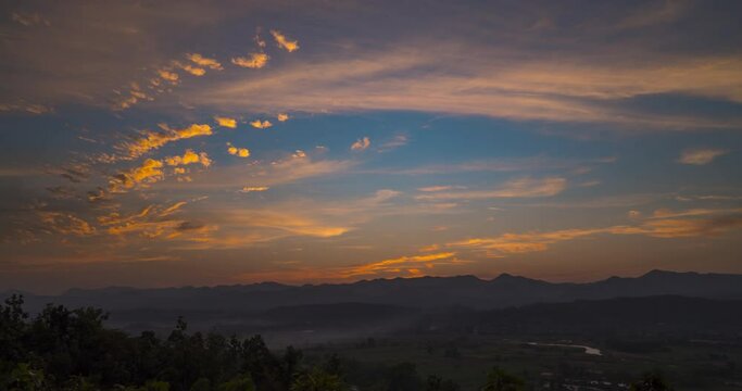 Time-lapse Motion clouds during the evening to dusk sky over the silhouette mountains in Northern Thailand