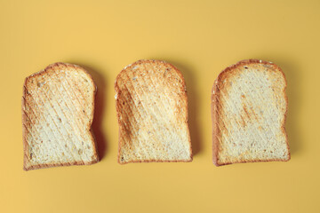 Set of three toasts isolated on yellow background.