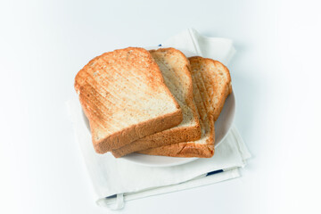 stack of toast on white plate and white placemat on white background, top view,isolate