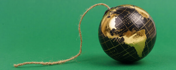Ecological problems. Planet earth in the form of a bomb with a wick on a green background - the destruction of ecology