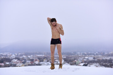 Guy snow showers for the hardening. Naked man body hardening in cold snow. Winter fun, tempering...