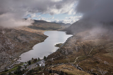 Fototapeta na wymiar Aerial view of flying drone Epic Autumn Fall landscape image of view along Ogwen vslley in Snowdonia National Park with moody sky and mountains