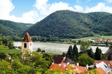View of a tower, the Danube river and a little mountain at the east side of Dürnstein.