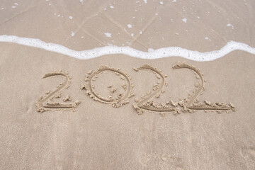 Text 2022 on sand beach Concept for new year is coming year