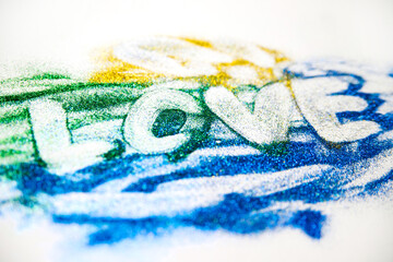 The inscription is made of small sequins. Multicolored sequins on a white background. valentine's day.