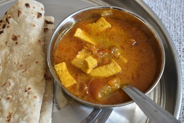 Famous indian food recipe paneer or cheese with roti in thali