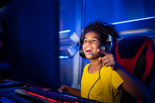 Young African American gamer just won the video game tournament and celebrating.