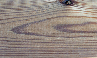 Part of a wooden board and a knot on the side