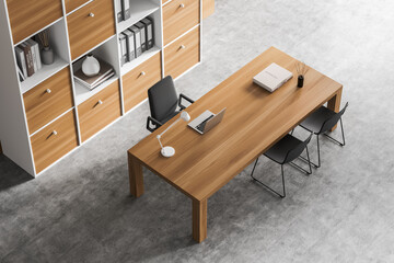 Top view of business room interior with desk and seats, bookshelf on grey floor