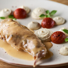 Tasty spicy rabbit stew in tomato sauce with white wine and herbs close-up on the table