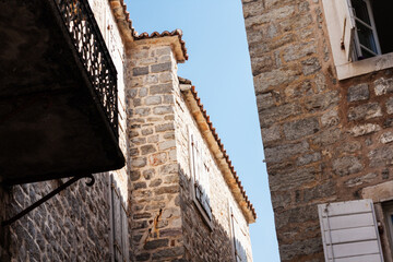 Street and landscape of Old town Budva, Montenegro: medieval city, ancient walls and red tiled roof, beautiful view