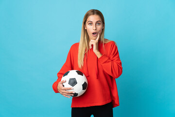 Young football player woman isolated on blue background intending to realizes the solution while lifting a finger up