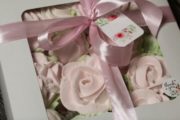 Homemade marshmallow in a gift box. Zephyr in the form of roses. Close-up shot.