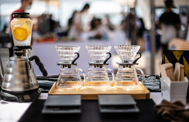 A set of glasses for brewing coffee with a drip.
