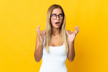 Young blonde woman isolated on yellow background stressed overwhelmed