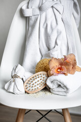 Spa composition with bath accessories and Thai orchid flowers.