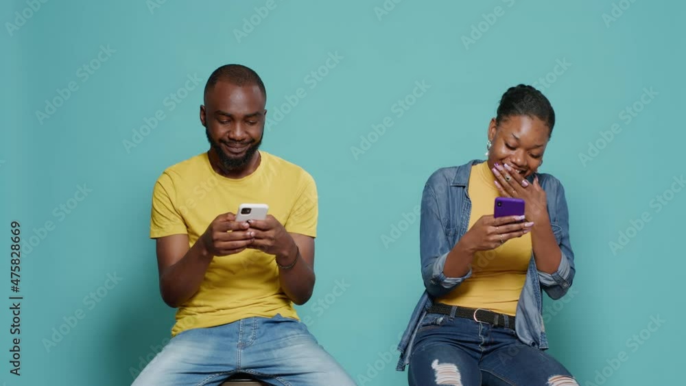 Poster modern people looking and smartphone screen and using technology to have fun in front on camera. cou