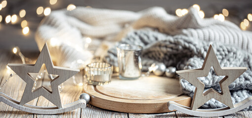 Cozy winter composition with decor details on blurred background with bokeh.