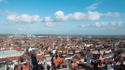 Fototapeta na wymiar cityscape of Bruges, with red ceiling and the Church tower