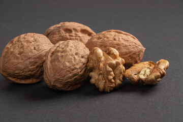 Walnuts scattered on a dark background, macro
