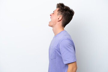 Young handsome Brazilian man isolated on white background laughing in lateral position