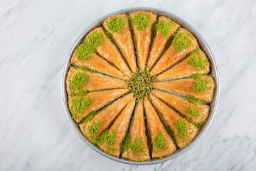 Carrot Slice Baklava (Turkish: Havuc Dilim Baklava) on tray. Traditional Baklava from Gaziantep, Turkey. Baklava with pistachio on marble background.
