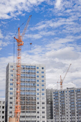Fototapeta na wymiar Hoisting crane and building of houses
