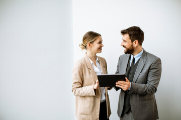 Young people with tablet by the wall in the office